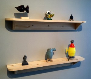 Top shelf: Catfish (made from eyeglass case), Delivery, Ceramic Spaceship.  Bottom: cast metal spaceship, ceramic vessel, assemblage spaceship.  