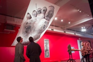 Visitors view work by Nathan Margoni.  Photograph by Larry Rippel.  © 2014