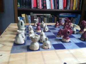Chess Set, glazed ceramic pieces, wooden board.  